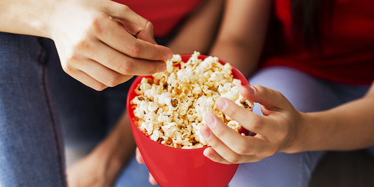 Friends are enjoying sweet and delicious popcorn together.